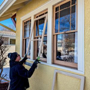 Restoring historic wooden windows with professional window repair services.