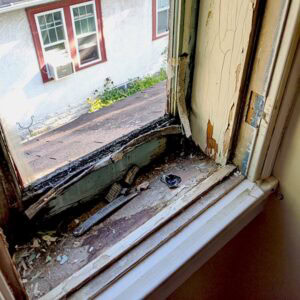 Cracked window frame repair for home restoration.