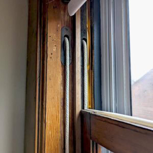 Old window sash cord and pulley system for window restoration.
