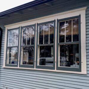 Restored historic window with updated paint and repairs for enhanced curb appeal.