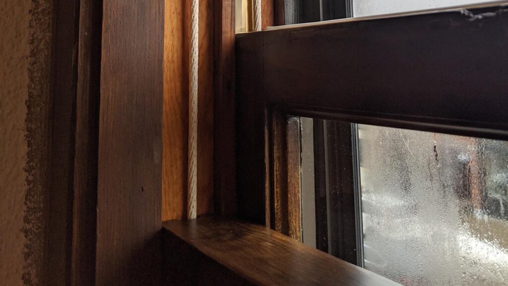 Weathered wooden window frame restoration by Hayes Window Restoration.