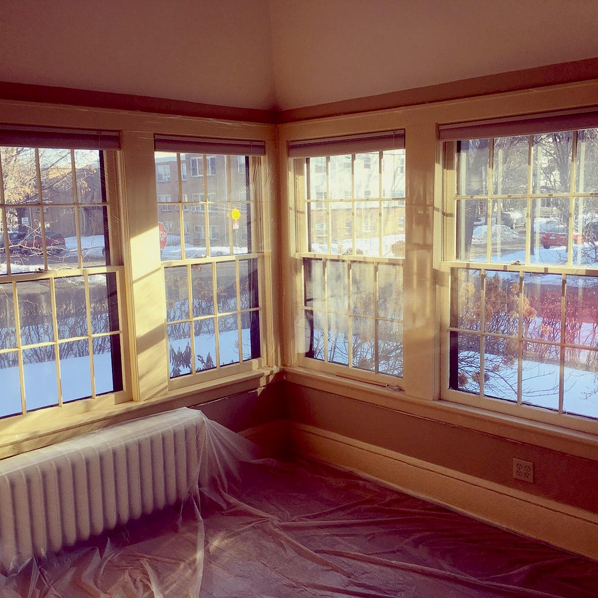 Replacement window panes in a cozy, sunlit room during window restoration.