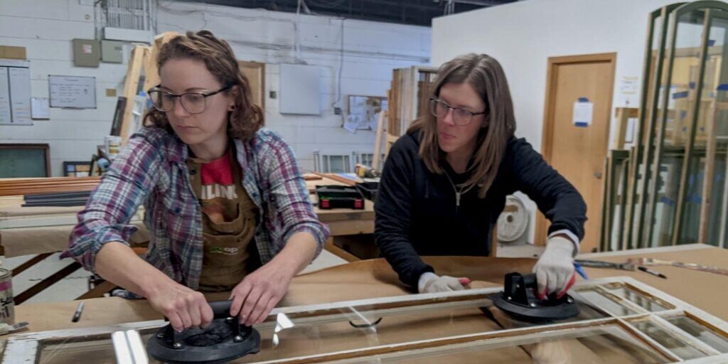 Newly restored historic windows being carefully polished and sealed at Hayes Window Restoration workshop.